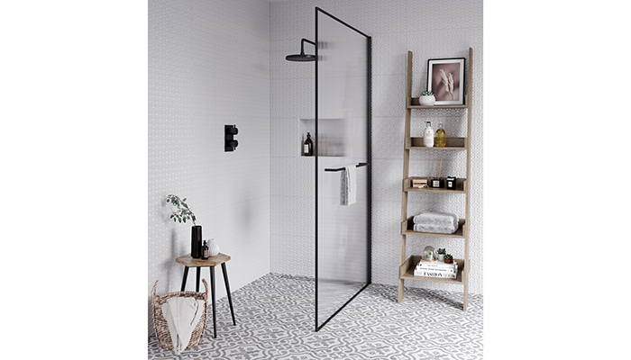 Aqata’s reeded glass wetroom panel can be framed in chrome, gold or matt black, as shown here