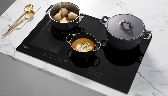 The Whirlpool 770 mm black glass induction hob (WF S3977 NE) boasts intelligent 6TH SENSE® technology for an intuitive cooking experience