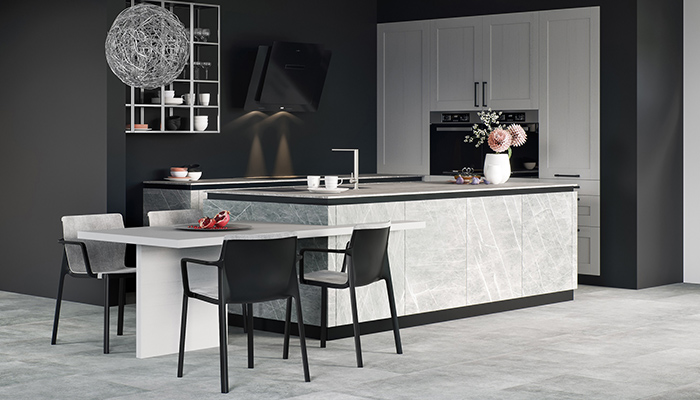 The island in Villeroy & Boch’s Cera kitchen, shown here in Zahia Stone Silk, flows seamlessly into the dining table