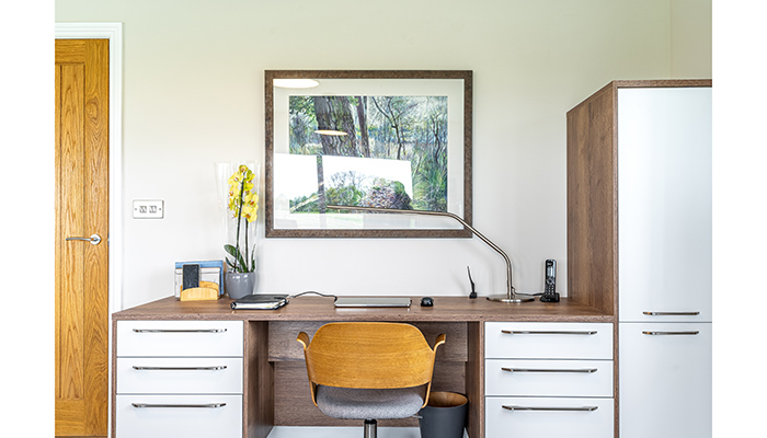 Michael enjoys painting – one of his works is hung above the home office area