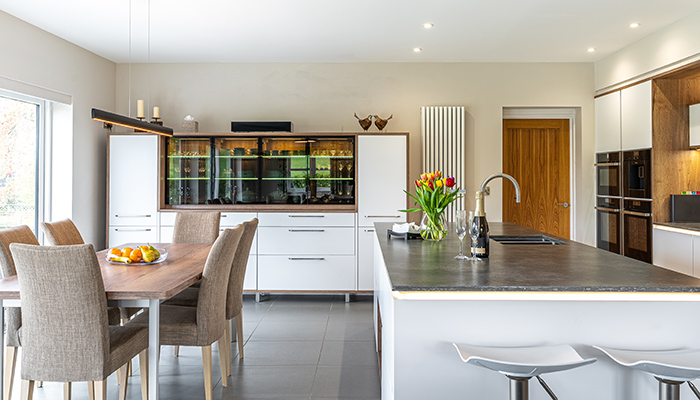 The dresser can be seen at the far end of the room, while the island features a Blanco sink and Quooker tap
