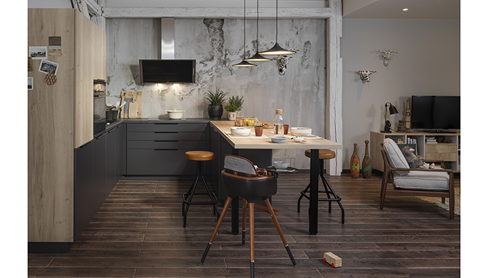 The Arcos Mix collection from French manufacturer Schmidt comes in 29 interchangeable colours and finishes, including Harvey wood and Caneo lacquer as seen here. In this design, the generous peninsula, which houses handy cubbyholes, separates kitchen from living area, while a walk-in larder helps keep kitchen essentials neatly concealed from view 
