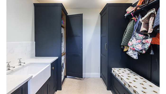 Featuring Arbor Lane Interiors’ in-frame staff bead Shaker cabinetry, manufactured for a kitchen retailer in Essex, this practical space features a stacked appliance solution and bootility area with made-to-measure furniture and storage solutions – handpainted in Bond Street by Mylands