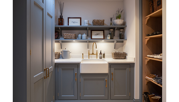 This ultimate bootiity room by Humphrey Munson includes all the essential elements such as hidden laundry appliances, a bench seat with lift-up storage and hooks above, and plenty of open boot storage. Cabinetry is from the Nickleby range – finished in Goose Iron with bespoke Marton handles by Joseph Giles – offset by quartz worktops and limestone flooring