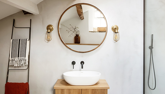 The mirror in this smart bathroom is perfectly framed by a pair of Industville’s Orlando wire cage bathroom lights, which are made from brass and rated IP20. Interior design by www.sturmanco.com