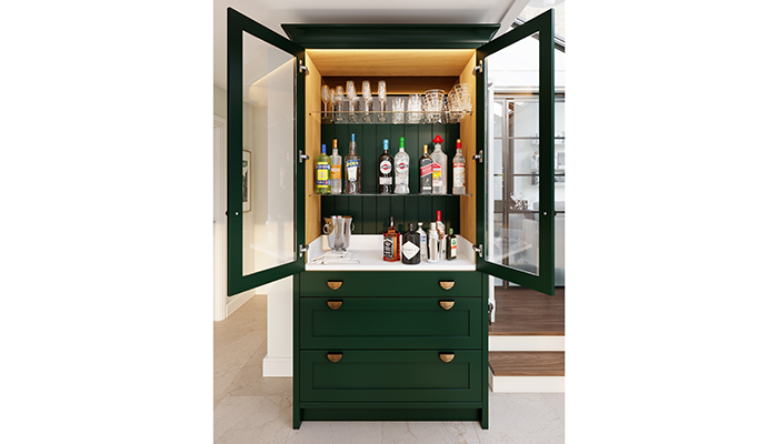 The new Thistleton drinks pantry in Thicket with beaded back panels, mirrored splash back behind the top shelf, a counter in Minerva solid surface and Dark Brushed Brass Ribbed Elipse handles