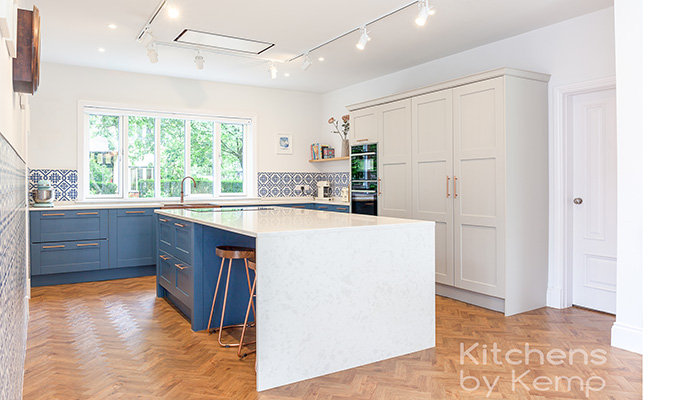 Kitchens by Kemp and Livedin365 collaborated on this project in Chorlton, Manchester, where the kitchen was previously situated at the rear of the property and was redesigned to be at the front, with an open-plan layout that features kitchen, pantry, dining and utility areas. Solid timber Shaker-style doors were chosen, along with finishing touches such as a Quooker tap that has been specially coated to match the sink