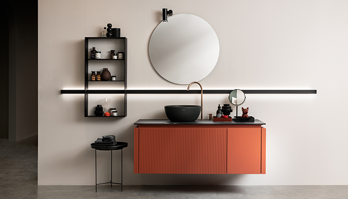 Libra, the yet-to-be-launched collection from Scavolini, will give consumers a choice of flat or ribbed doors (featuring either horizontal or vertical ribbing), with a version of the horizontal ribbed door also available in glass. Pictured here is a wall-mounted vanity unit featuring a Morocco Red matt lacquer slatted door and a Morocco Red matt lacquer flat door, with a Slate Black glass top and black ceramic countertop washbasin