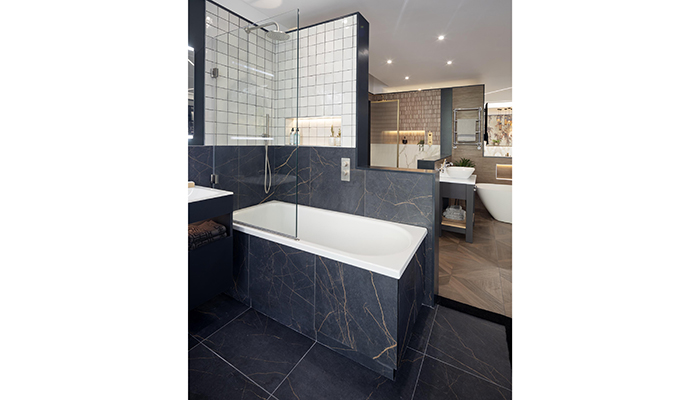 Bette inset bath clad in A&M Tiling Minnie tiles with Samuel Heath brassware and The Shower Lab shower screen