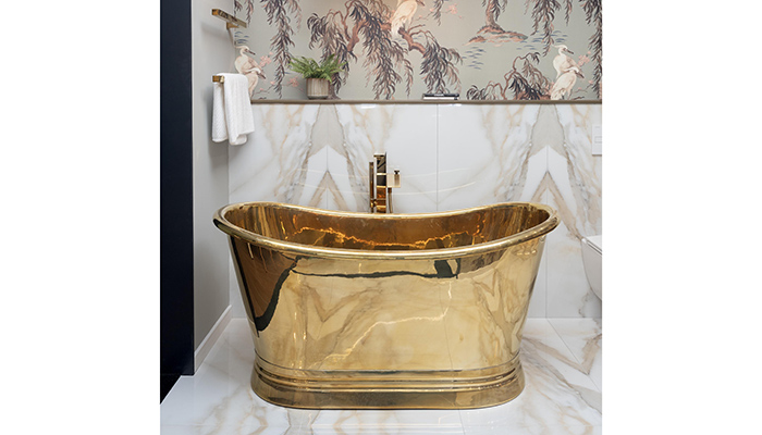 A BC Designs bath set against Ca’Pietra Magnifique book-matched tiles and House of Hackney Zeus wallpaper