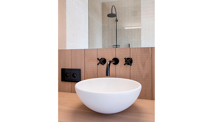 The Dornbracht Tara wall-mounted basin mixer and spout in Matt Black have been perfectly matched with the Tara shower pipe with shower mixer creating an industrial-vibe in this bathroom