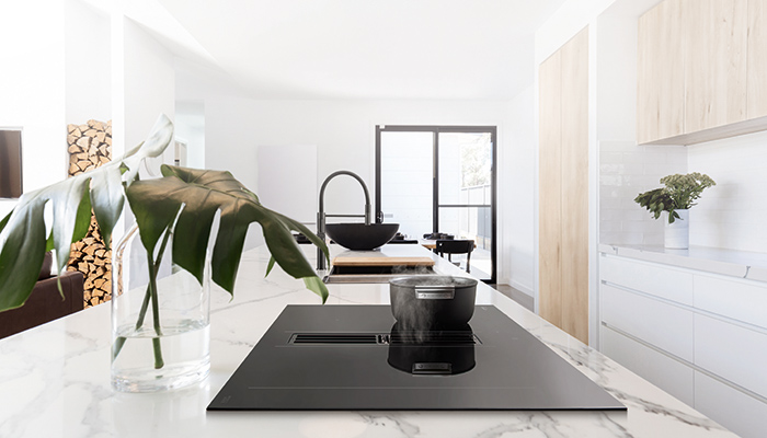 Sleek and streamlined, Smeg’s HOBD472D induction hob with integrated hood provides discreet extraction