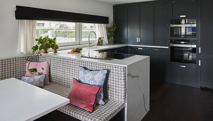 Maximising every inch of space in this two-bedroom London apartment, Higham Furniture’s contemporary Inset Handle Shaker kitchen has a waterfall peninsula that incorporates L-shaped banquette seating with integrated storage 