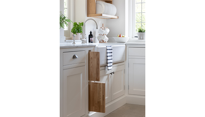The Edgworth double white butler style sink is shown with Perrin & Rowe Phoenician monobloc tap 