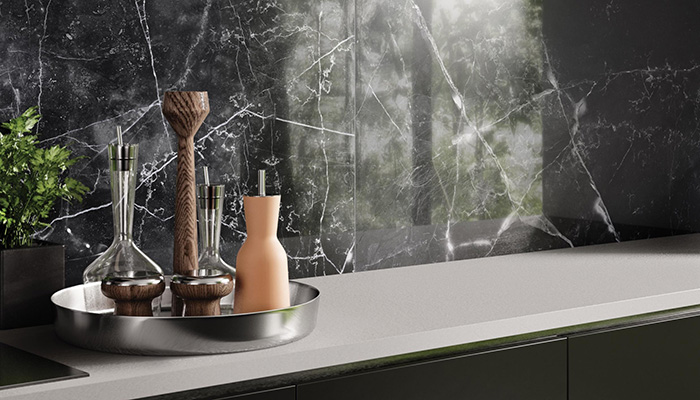 This dark splashback – Armani Marble by RAK Ceramics – looks striking against the white surface and pairs wonderfully with the dark cabinetry