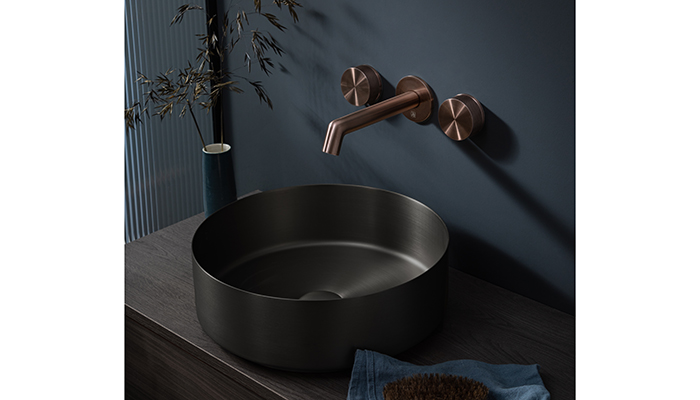 Reflecting the trend to mix metals within the bathroom, JTP’s EVO 3 Hole wall-mounted basin mixer in Brushed Bronze is seen here with the VOS Grade 316 stainless steel countertop basin in Matt Black