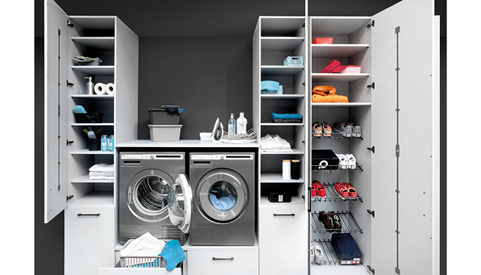 Rotpunkt Zerox utility room furniture, seen here in Daylight Grey, is a comprehensive system that includes custom laundry cabinets to house washing machines and tumble dryers at an ergonomic working height. Available in 26 colours options