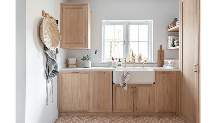 This Scandi-style cabinetry has been used to design a minimalist, clutter-free  utility room. Featuring the Shaws of Darwen butler sink and Perrin & Rowe Ionian Mixer and Rinse tap made from high-quality brass and deeply plated for longevity, it’s available in a range of finishes including Chrome, Nickel, Pewter, and Aged and Satin brass