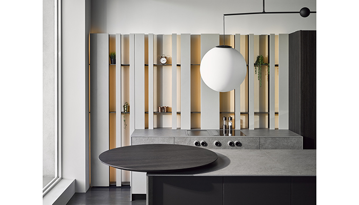 The Cut Minima kitchen in Argilla Grigio (Grey Clay) and Pure island in Moka Fenix, with Inalco MDi Jasper sintered stone worktops and The Cut Tonda rotating table in Rovere Termotrattato (heat-treated oak) veneer, Luceplan Malamata 48 pendant light 