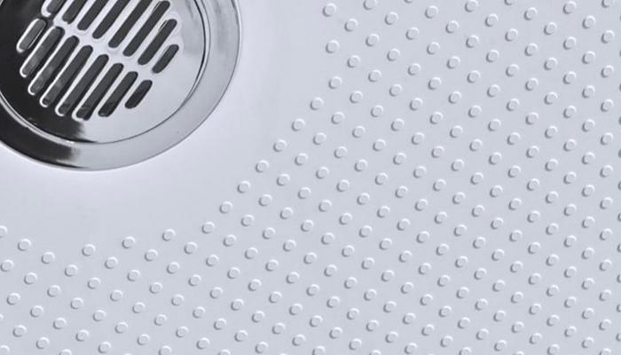 The SENSTEC anti-slip shower tray is made from solid stone resin, and features an innovative 'dimple' on the surface that has been developed with the aerospace industry, and is said to provide grip without impacting on either comfort or cleanability