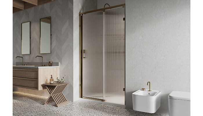 Liberty sliding door alcove set up in Brushed Brass with fluted glass