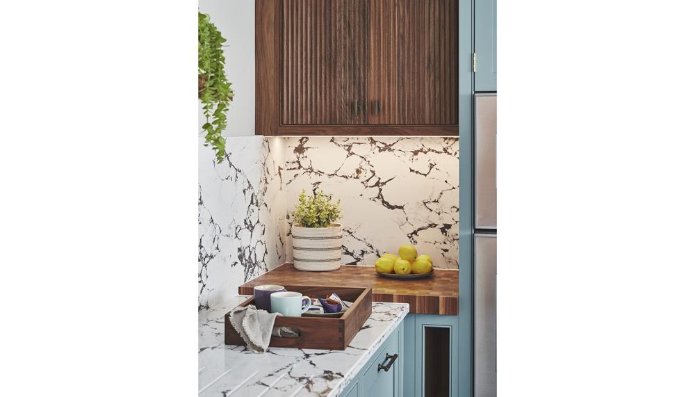 Textured reeded cabinets and a veined waterfall worktop/splashback in the Anmer kitchen