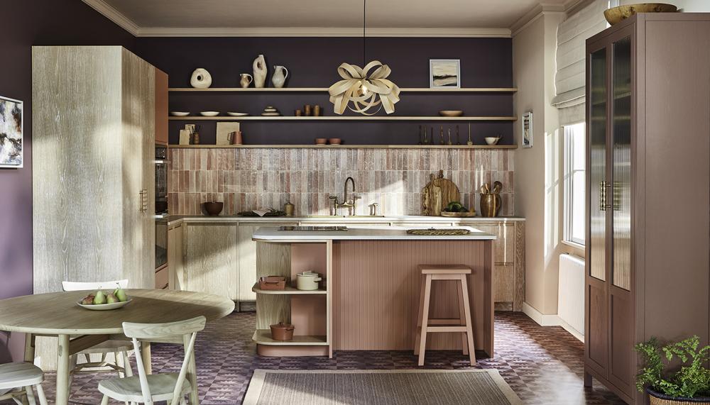 This bright and colourful kitchen by Naked Kitchens demonstrates how a curved corner on the island can make the space feel more open and free flowing